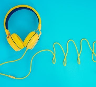 Yellow over-ear headphones on bright blue background