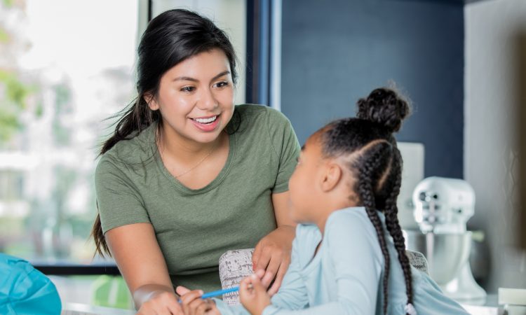 female teaching working with young student