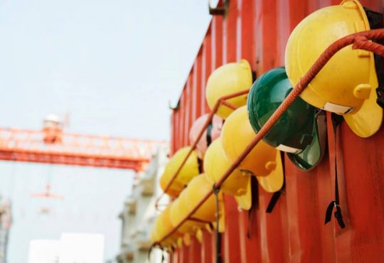 hard hats hanging on red trailer