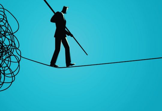 man walking on tightrope