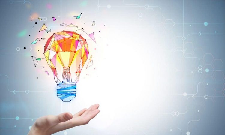 colourful lightbulb hovering over open palm of hand