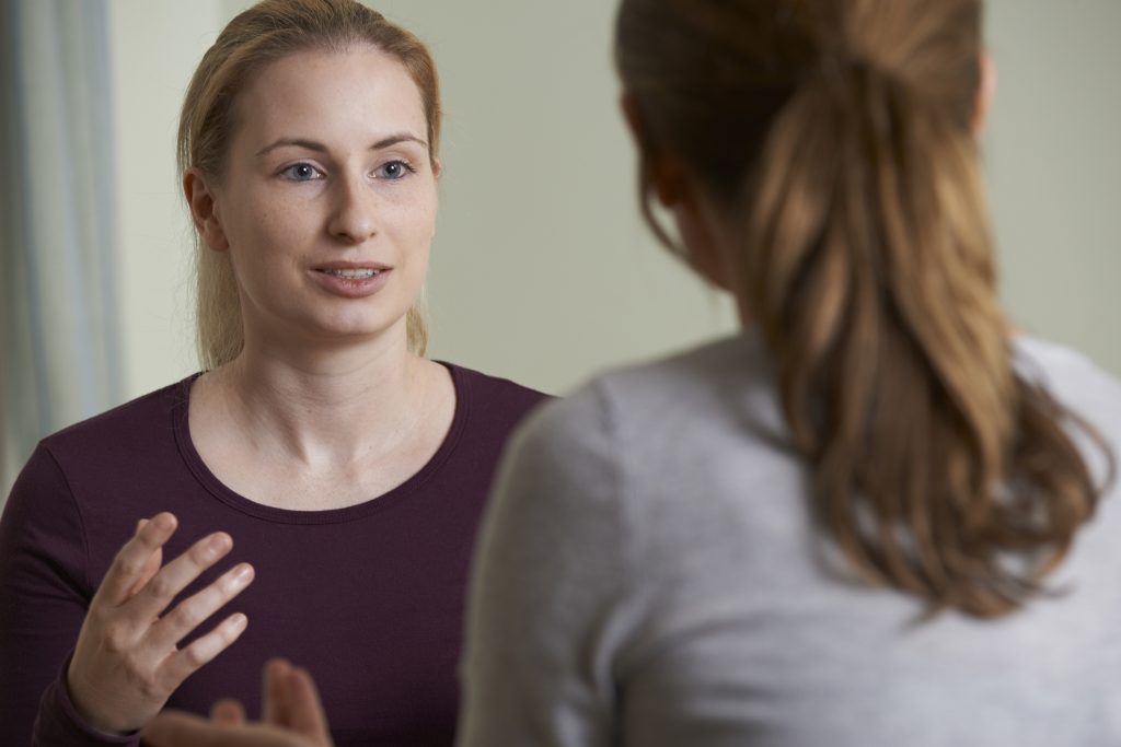 Young Woman Discussing Problems With Counselor