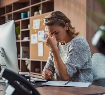 woman working at computer with headache