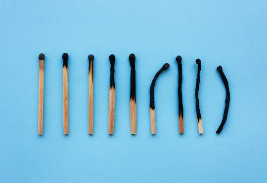 Burned matches in a row on a blue background.