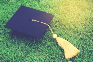 shot of graduation hats on the grass