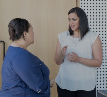 two women talking in office