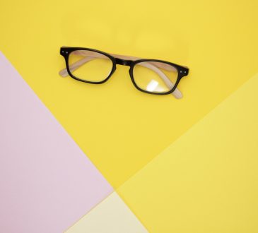 pair of glasses on yellow backdrop