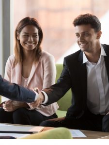 people shaking hands in office