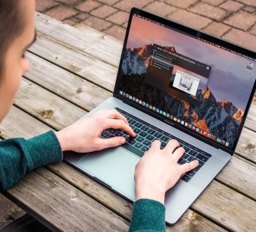male student typing on laptop