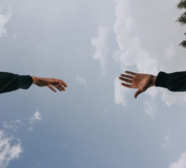 hands reaching toward each other