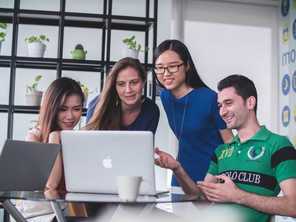 students sitting around computer together