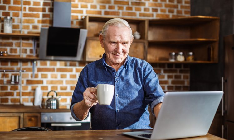 older man using laptop