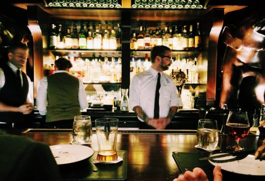 bartender standing behind bar