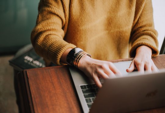 person typing on laptop