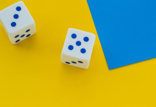 dice on bright yellow background