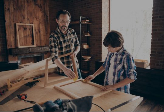 dad and son doing woodworking