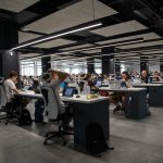 people working at desks in open concept office