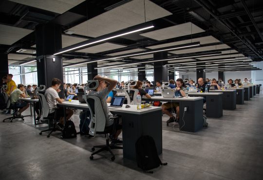 people working at desks in open concept office