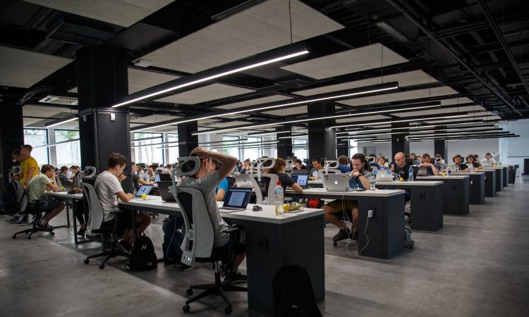 people working at desks in open concept office