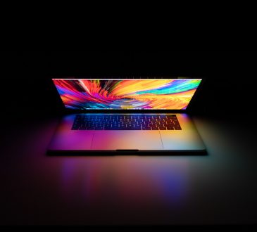 laptop on dark background with colourful screen