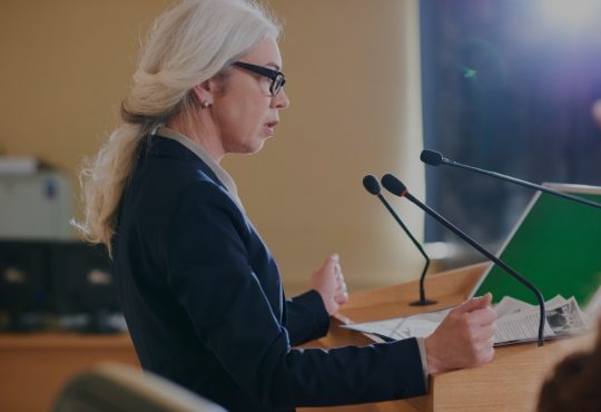 woman speaking at podium