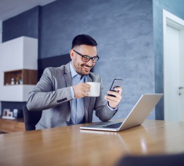 businessman looking at smartphone at home