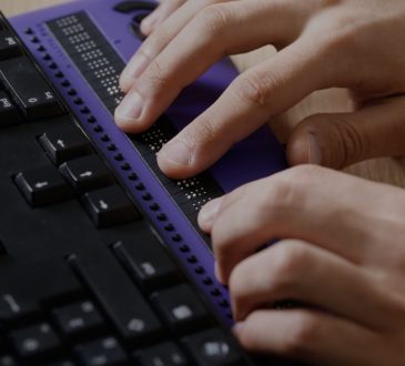 blind person using braille keyboard