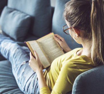 Young woman is reading book