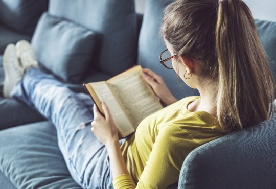 Young woman is reading book