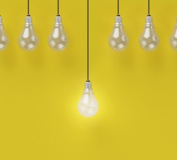 light bulbs hanging on yellow background