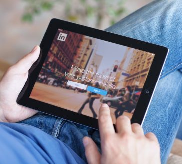 man using linkedin on tablet