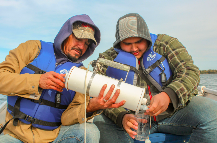 Two men in Water First program on boat