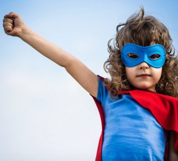 child dressed as superhero