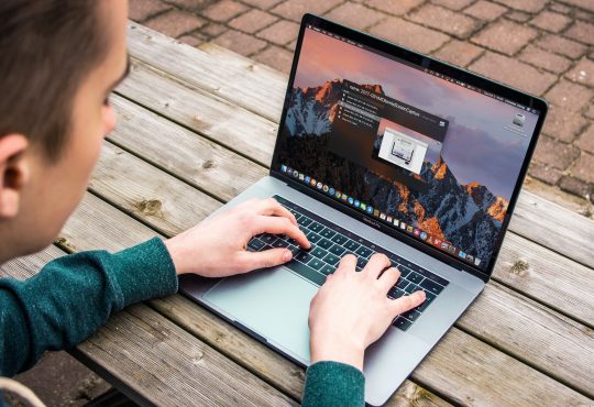 man typing on laptop