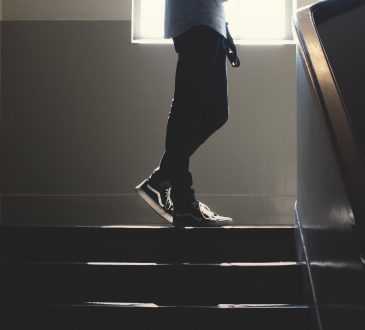 teen standing in stairway