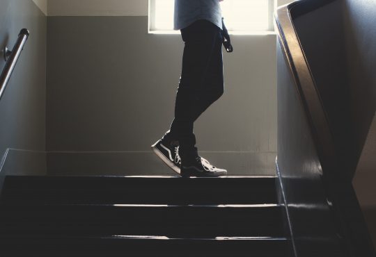 teen standing in stairway