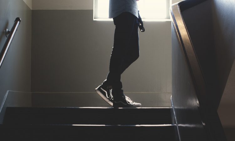 teen standing in stairway