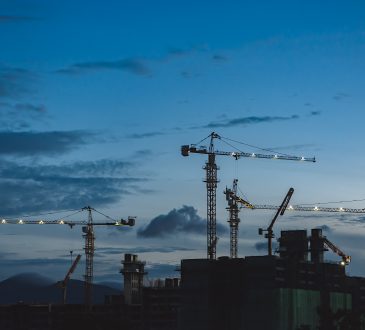 construction cranes against blue sky