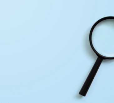 Magnifying glass on blue colour background