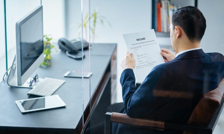 businessman reviews resume in office