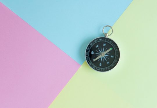 compass on multi-coloured background