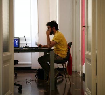 person sitting at kitchen table working
