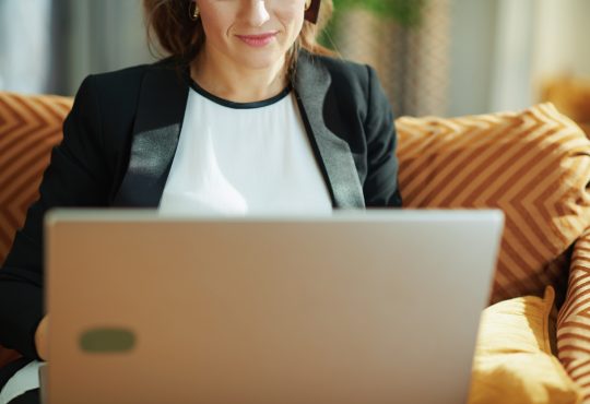 woman wearing blazer using laptop