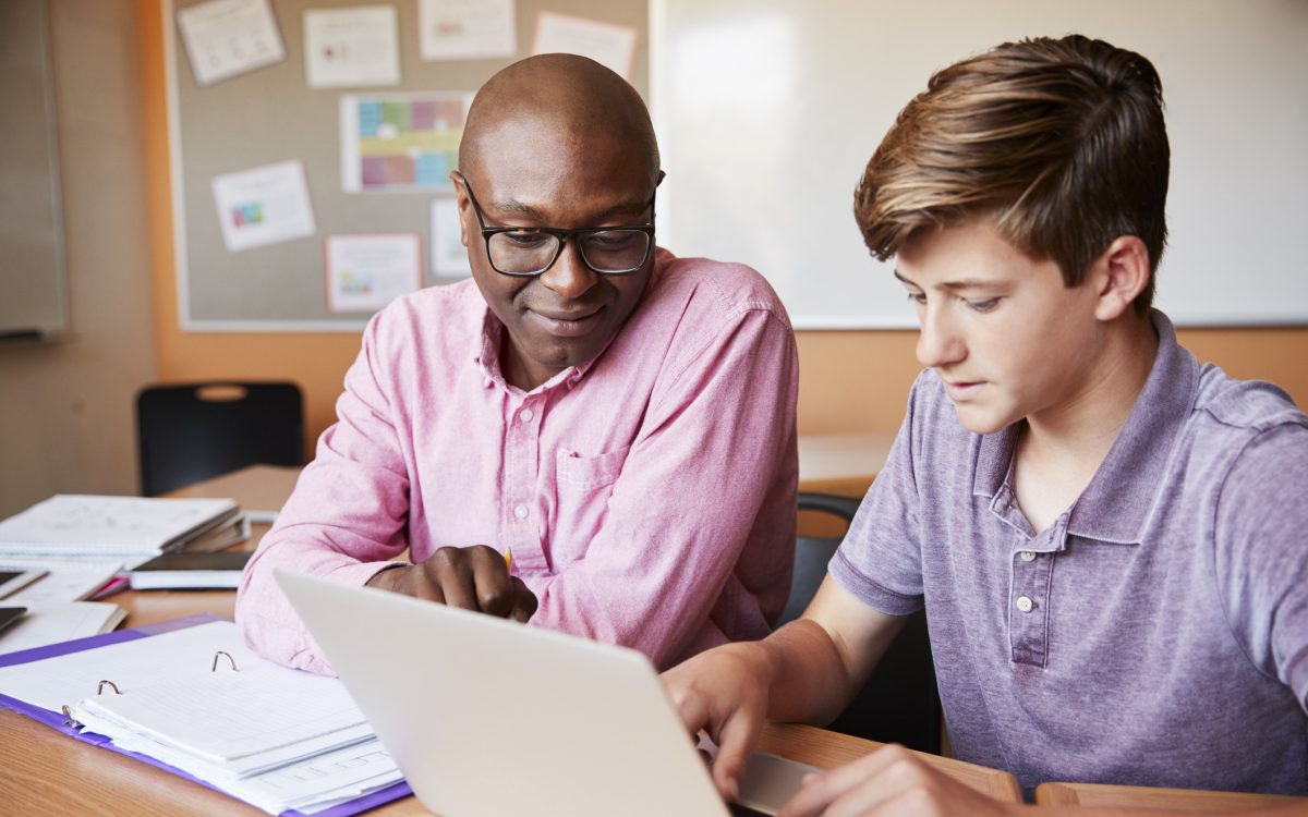 male tutor and student working together