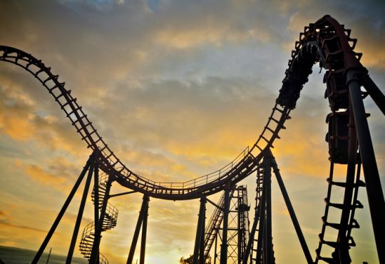 Roller coaster on sunset sky.