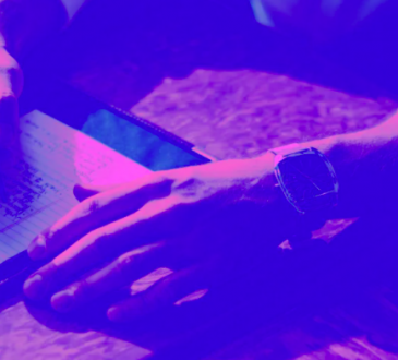 photo of person writing on paper with purple filter