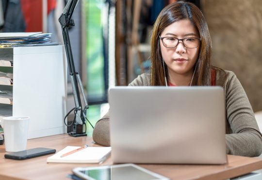 woman watching webinar on laptop