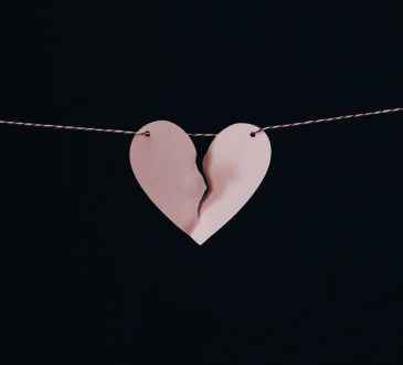 paper cutout broken heart hanging on string