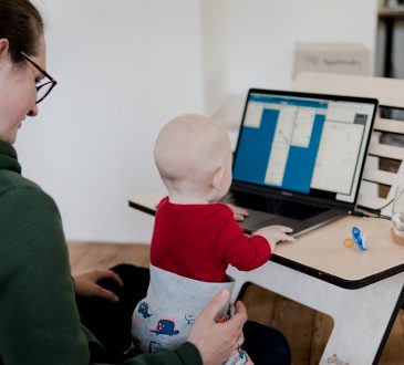 mom with baby looking at laptop