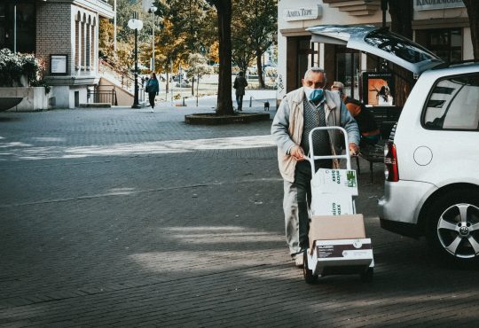 man pushing delivery cart